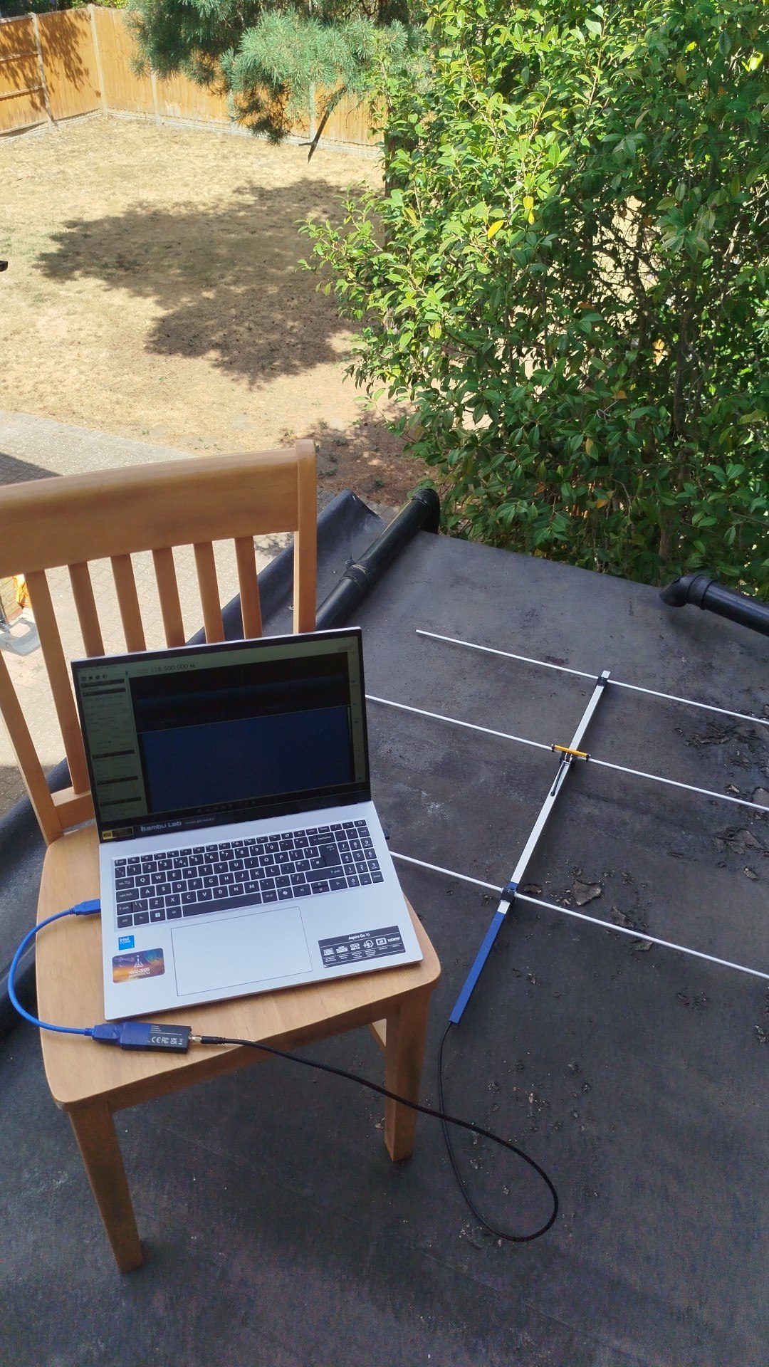 Yagi antenna and laptop running SDR software on a rooftop