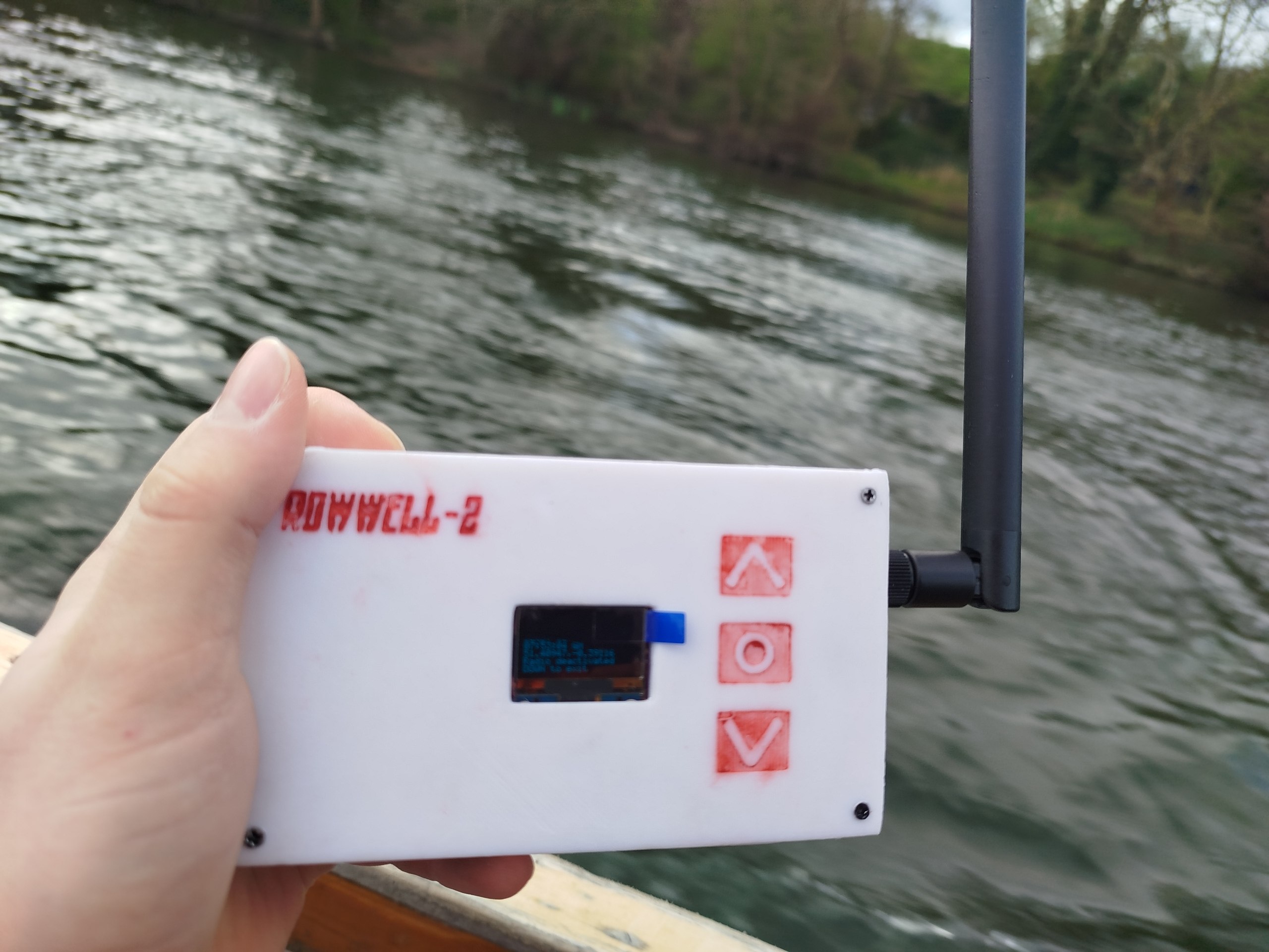 ROWWELL-2 handheld data logger held above a river