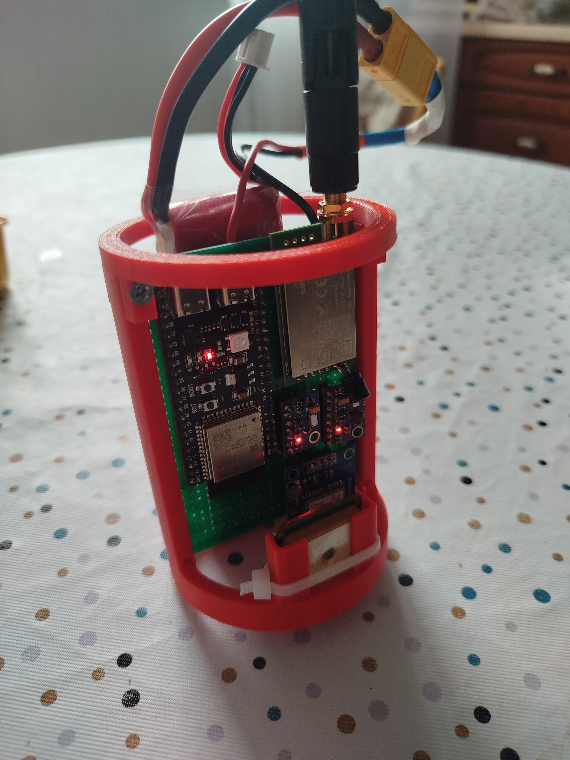 Molniya-1.0R flight computer in a red 3D-printed enclosure